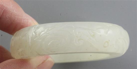 A Chinese white jade bangle or ring, diameter 5.7cm